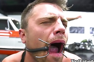 Buff BDSM sub gagged together with restrained by dom