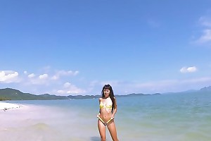 Micro bikini joshing at the end of one's tether sexy teen who walks on a beach
